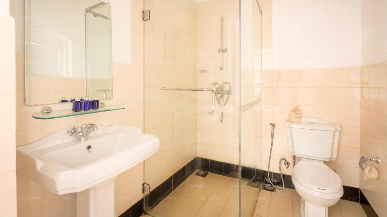 Bathroom with sink, toilet, and shower area.